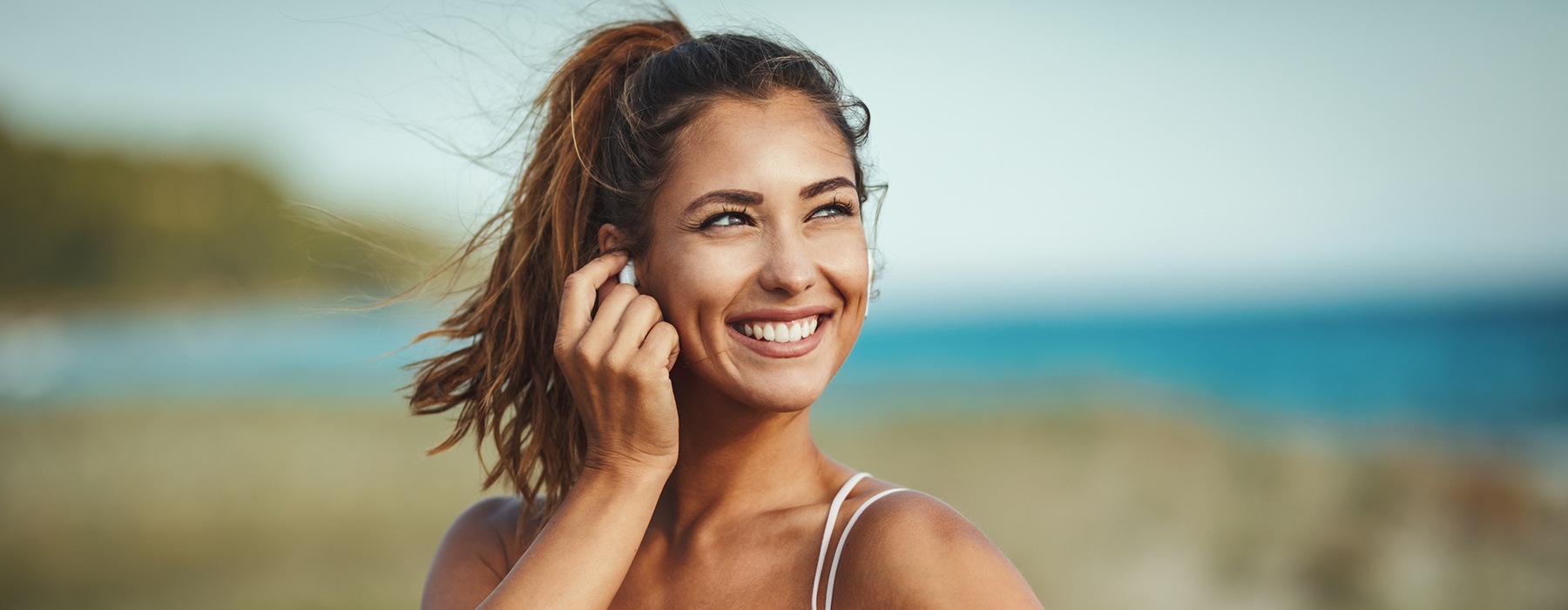 lifestyle image of a smiling woman outdoors