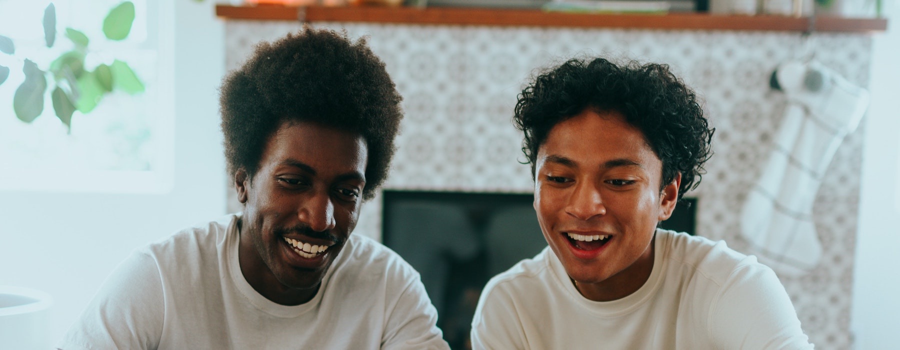 lifestyle image of a couple interacting over a video call in a bright living area